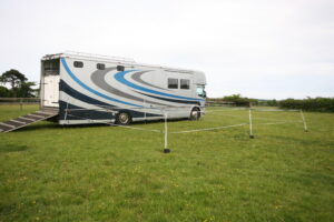 A pair of 8 by 5 overnight enclosures beside a lorry